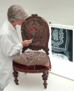 Kate Gill examining a 19th century chair from Chertsey Museum